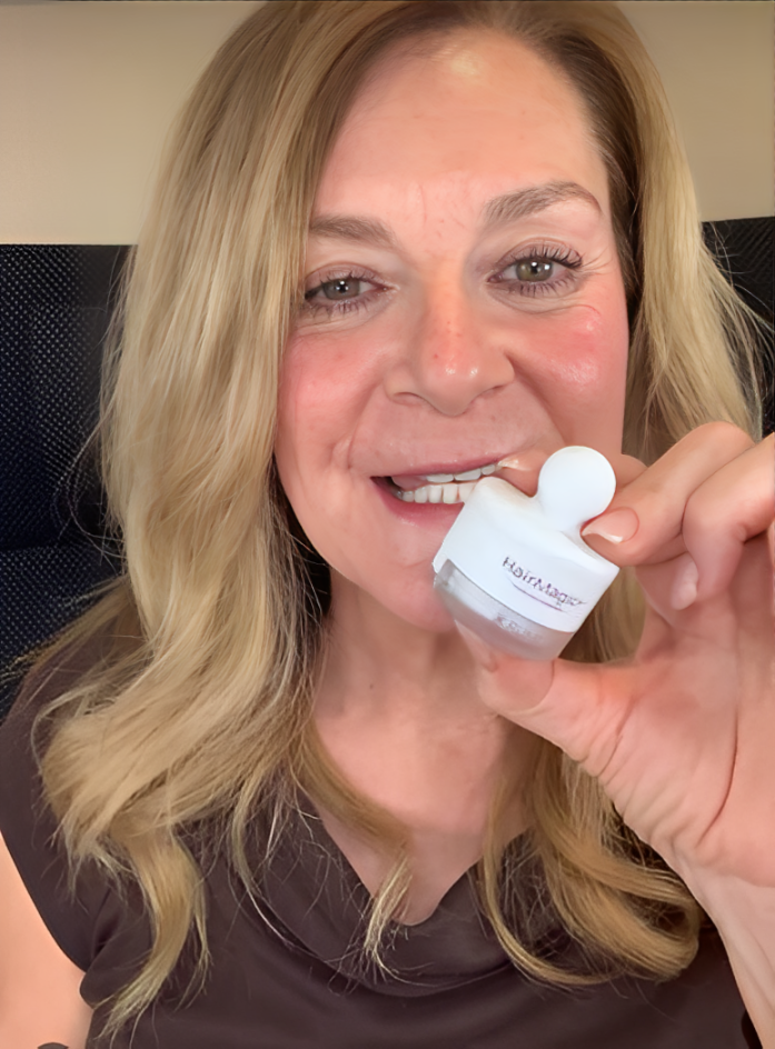 Smiling woman holding HairMagic+ hair powder for thinning hair and grey coverage